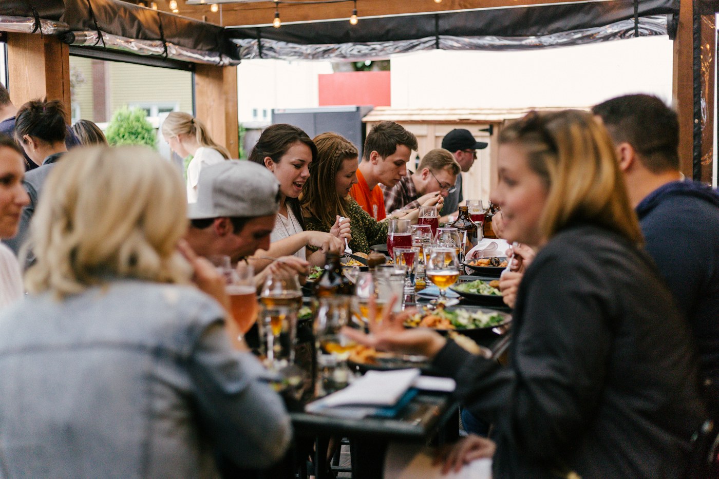People sharing food and conversation around a long table